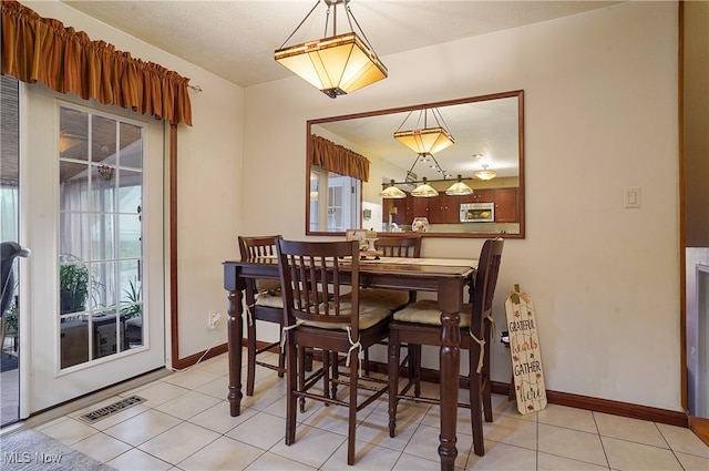 dining space with light tile patterned floors