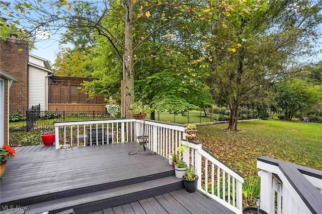 wooden deck with a lawn