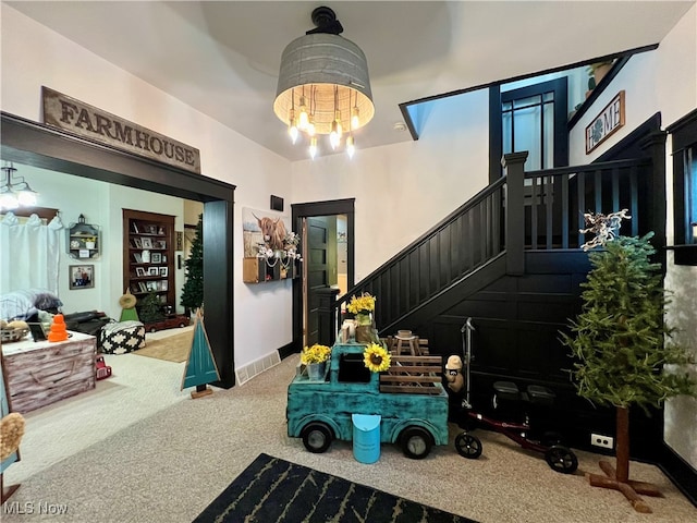 interior space featuring carpet flooring and an inviting chandelier