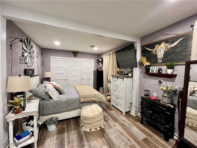 bedroom featuring hardwood / wood-style floors and a closet