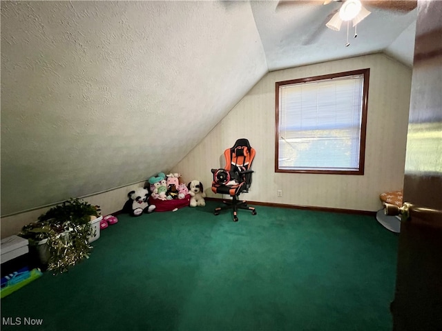 interior space featuring ceiling fan, a textured ceiling, lofted ceiling, and carpet flooring