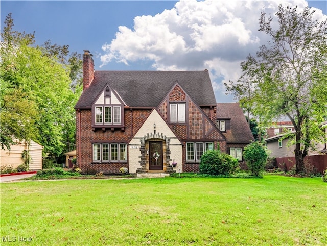 tudor-style house with a front yard