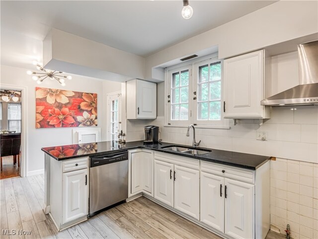 kitchen with dishwasher, light hardwood / wood-style floors, sink, white cabinets, and kitchen peninsula