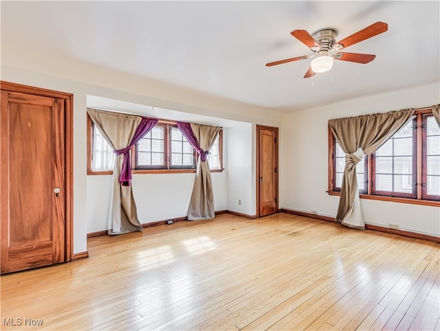 spare room with light hardwood / wood-style flooring and ceiling fan