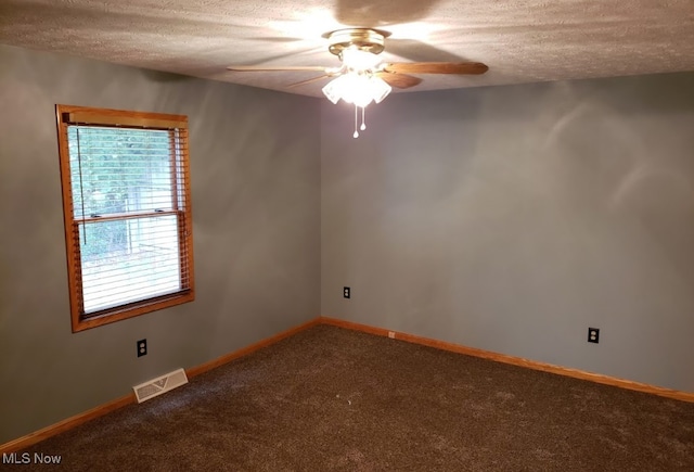 spare room featuring ceiling fan, a textured ceiling, and carpet flooring