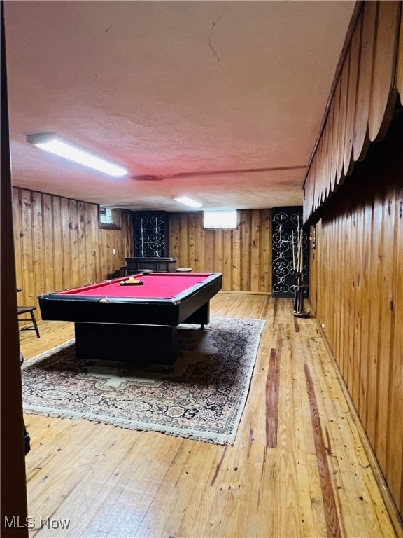 playroom with wood walls, light hardwood / wood-style flooring, and billiards