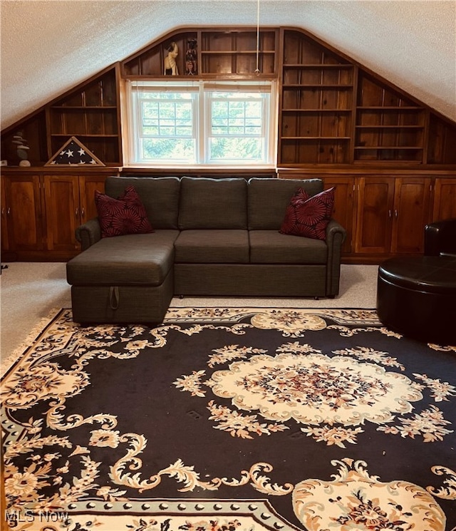 living room with built in shelves, carpet, a textured ceiling, and vaulted ceiling