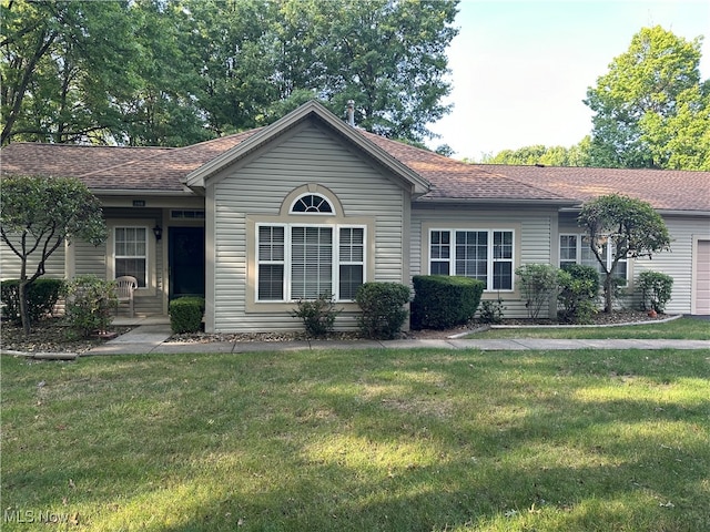 ranch-style home featuring a garage and a front yard