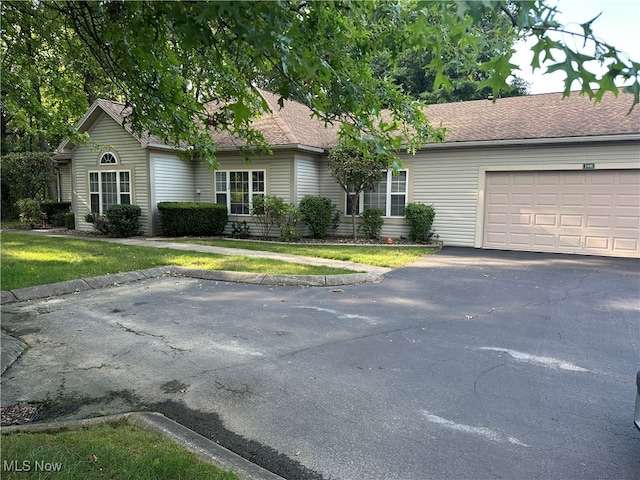 single story home featuring a garage