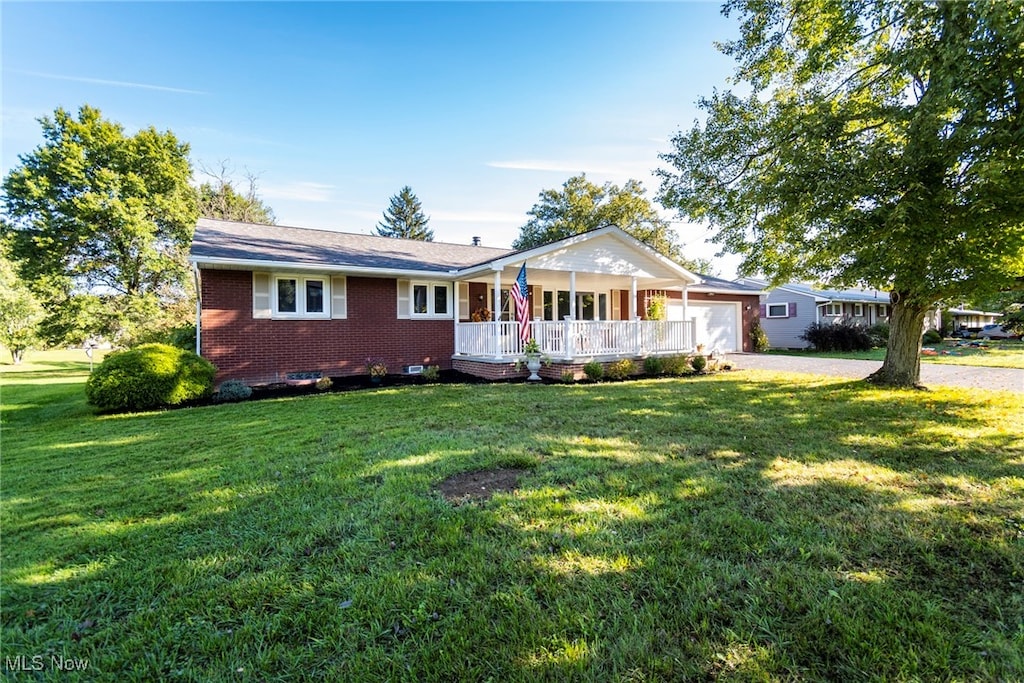 ranch-style house with a front lawn and covered porch