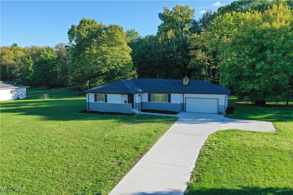 view of front of house with a garage and a front yard