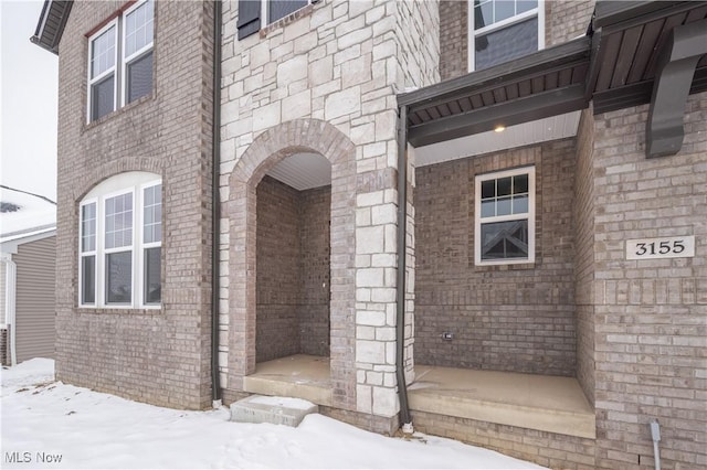 view of snow covered property entrance