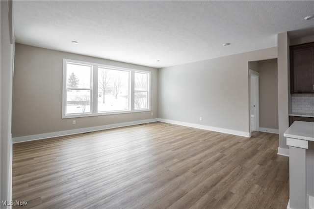 empty room with light hardwood / wood-style flooring