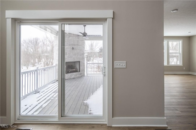 doorway to outside with ceiling fan and plenty of natural light