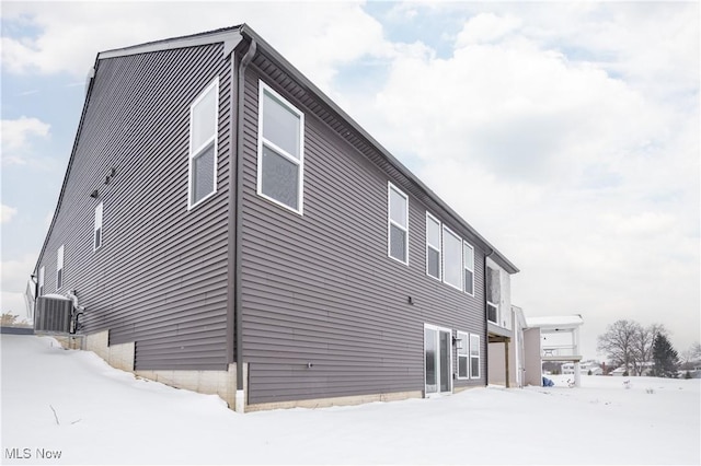 view of snow covered exterior with central air condition unit