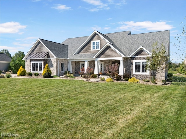 craftsman-style home featuring stone siding and a front yard