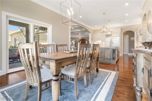 dining area with ornamental molding and dark wood-type flooring