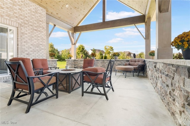 view of patio / terrace featuring a gazebo and an outdoor living space with a fire pit