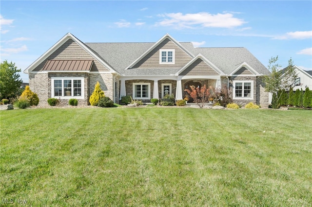 craftsman-style home with a standing seam roof, metal roof, and a front lawn