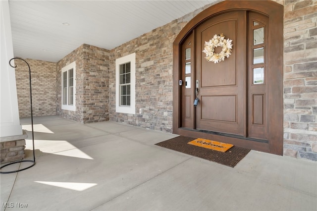 view of exterior entry featuring stone siding