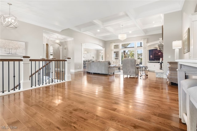 living room featuring coffered ceiling, beamed ceiling, a chandelier, and hardwood / wood-style floors