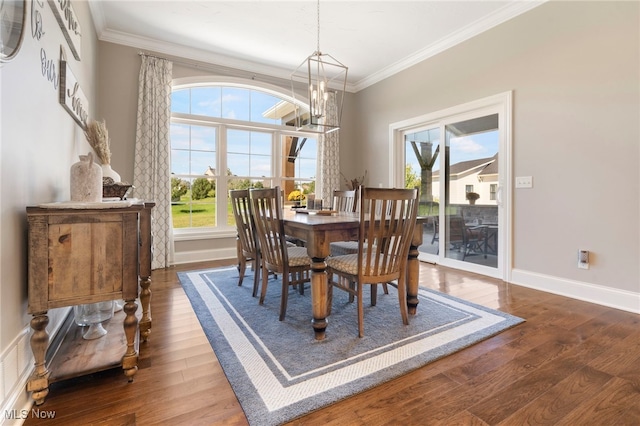 dining space with crown molding, dark hardwood / wood-style flooring, and a chandelier