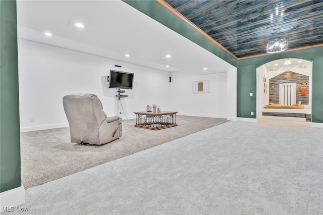 sitting room featuring carpet floors, recessed lighting, arched walkways, and baseboards