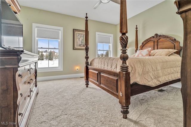 carpeted bedroom featuring ceiling fan and baseboards