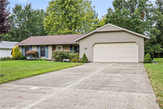 single story home with a garage and a front lawn