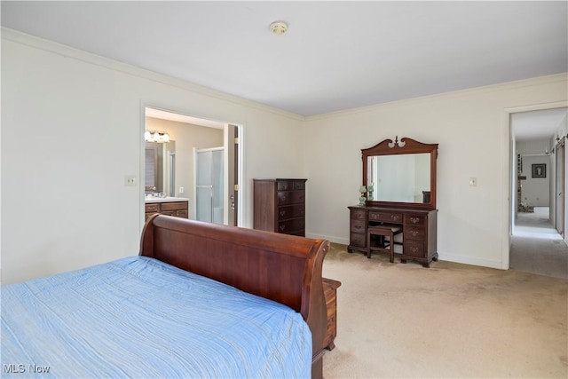 carpeted bedroom with crown molding and connected bathroom