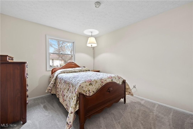 bedroom with carpet flooring and a textured ceiling