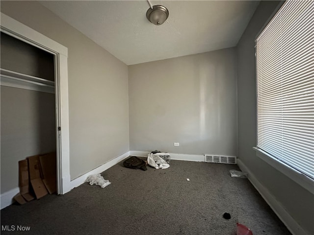 unfurnished bedroom featuring carpet flooring and a closet