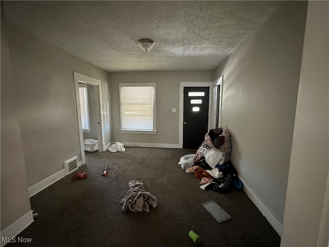 interior space featuring a textured ceiling