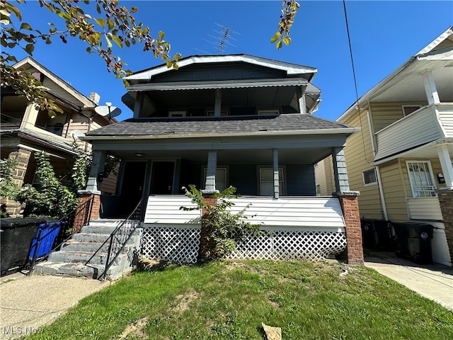 view of front of house with a porch and a front yard