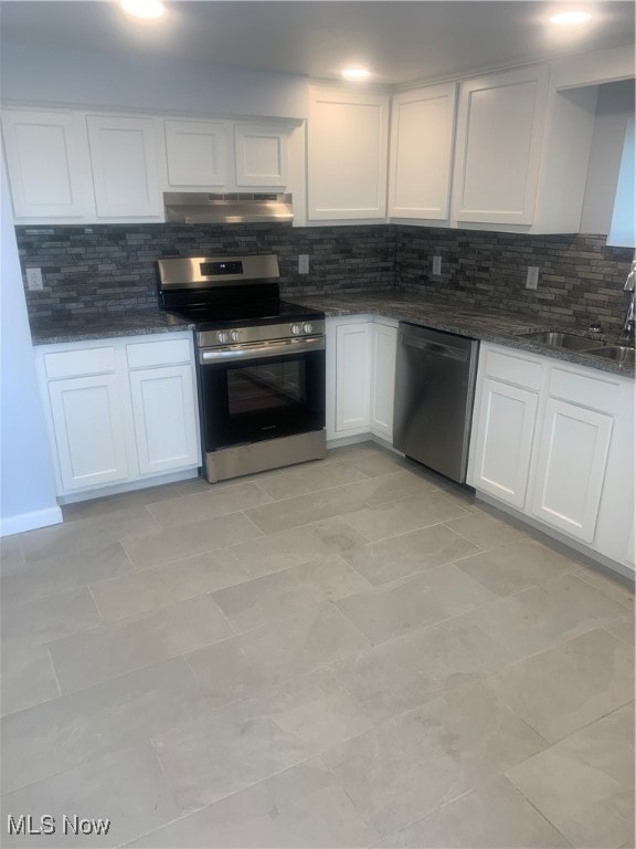 kitchen with white cabinets, stainless steel appliances, backsplash, and sink