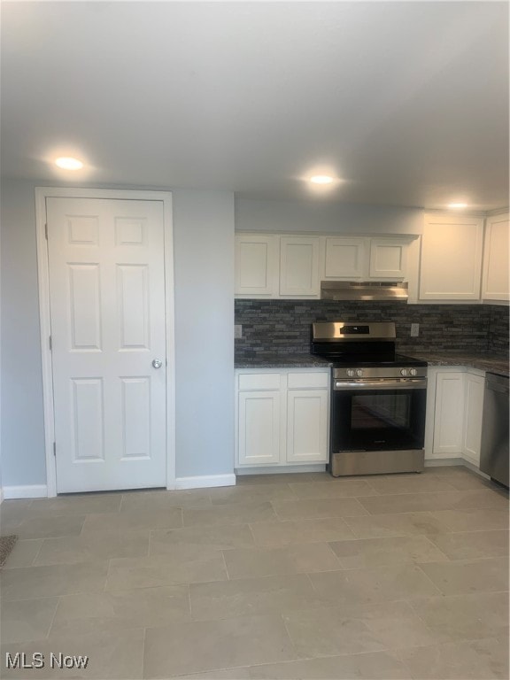 kitchen featuring stainless steel appliances, white cabinets, light tile patterned floors, and tasteful backsplash