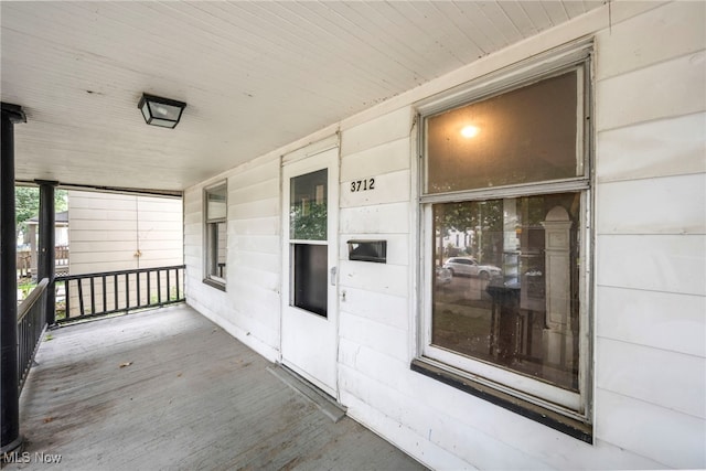 view of exterior entry featuring a porch