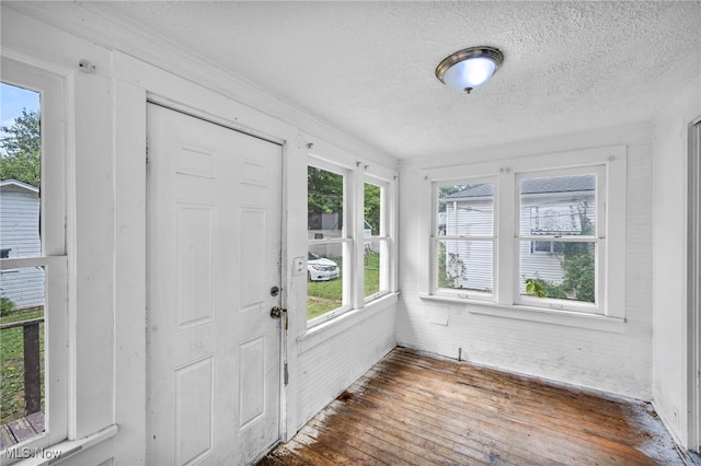 foyer entrance with a textured ceiling and dark hardwood / wood-style floors