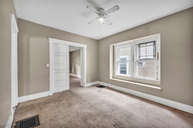 spare room with ceiling fan and carpet floors