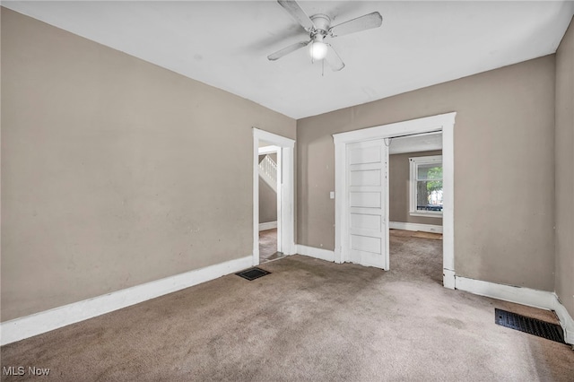 unfurnished bedroom with carpet floors, ceiling fan, and a closet