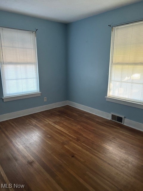 empty room featuring dark hardwood / wood-style flooring