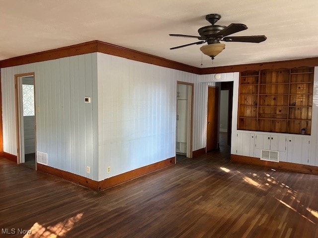 unfurnished room featuring ceiling fan and dark hardwood / wood-style flooring