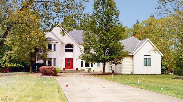 french country inspired facade featuring a front lawn