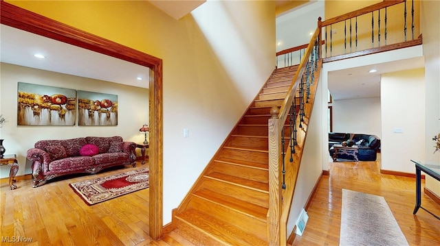 staircase with hardwood / wood-style floors