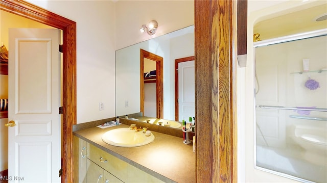 bathroom featuring vanity and a shower with door