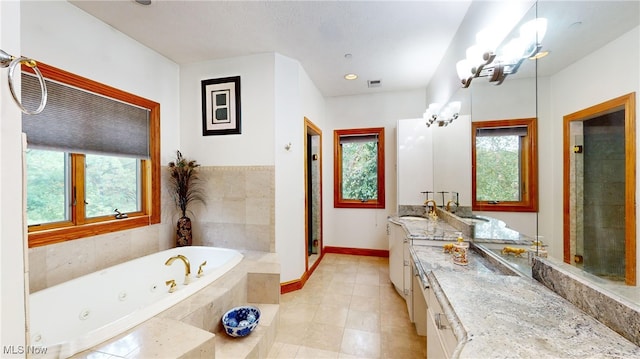 bathroom featuring independent shower and bath, tile patterned flooring, vanity, and an inviting chandelier