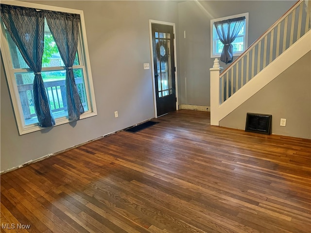 foyer with dark hardwood / wood-style flooring and a healthy amount of sunlight