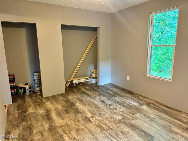 interior space with hardwood / wood-style flooring and a textured ceiling