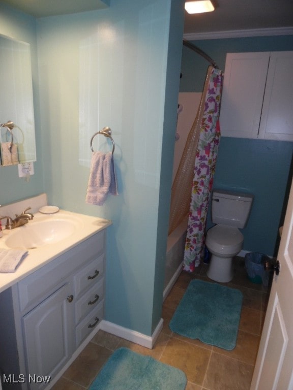 full bathroom with vanity, tile patterned flooring, shower / bath combo with shower curtain, crown molding, and toilet