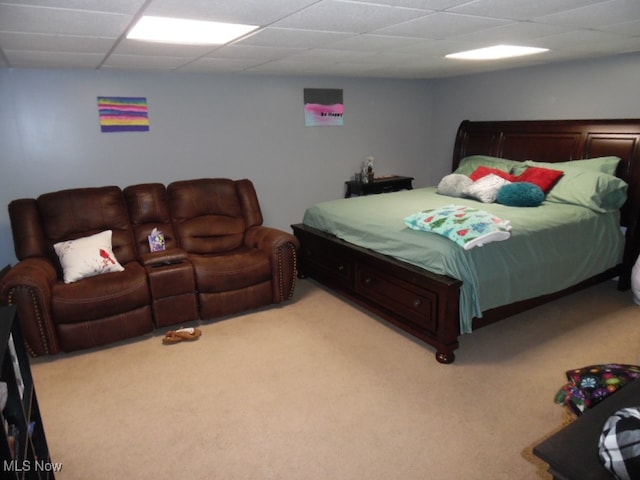 carpeted bedroom with a paneled ceiling